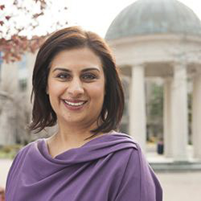 amita vyas a person with dark brown hair in a purple shirt in front of the tempietto on GW campus