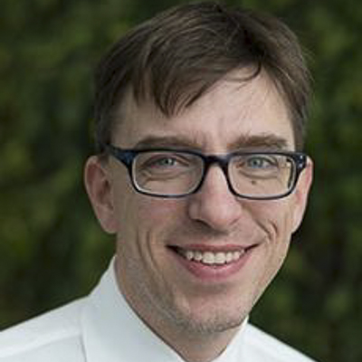 robert pless a person with short dark hair and a white shirt and glasses